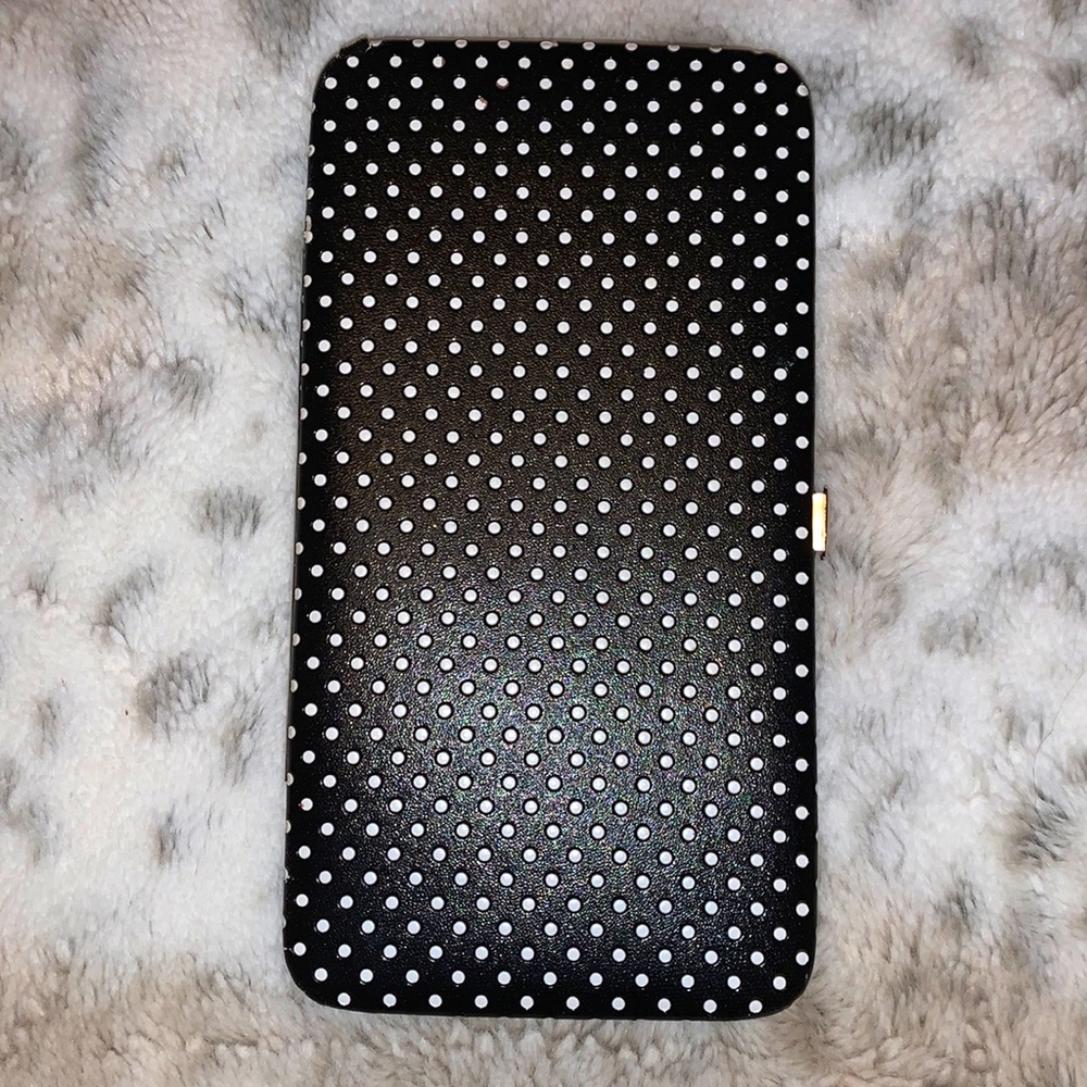 Black and white polkadot hand wallet.